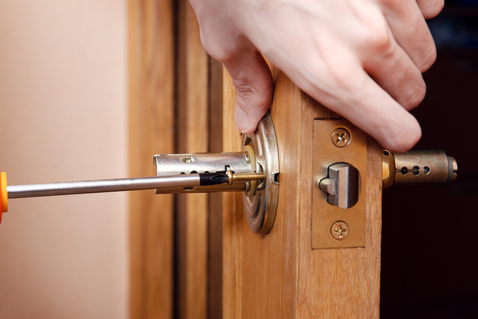 A locksmith fitting a replacement lock
