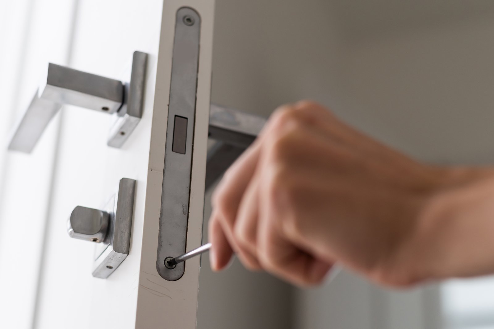 A locksmith fitting an additional lock