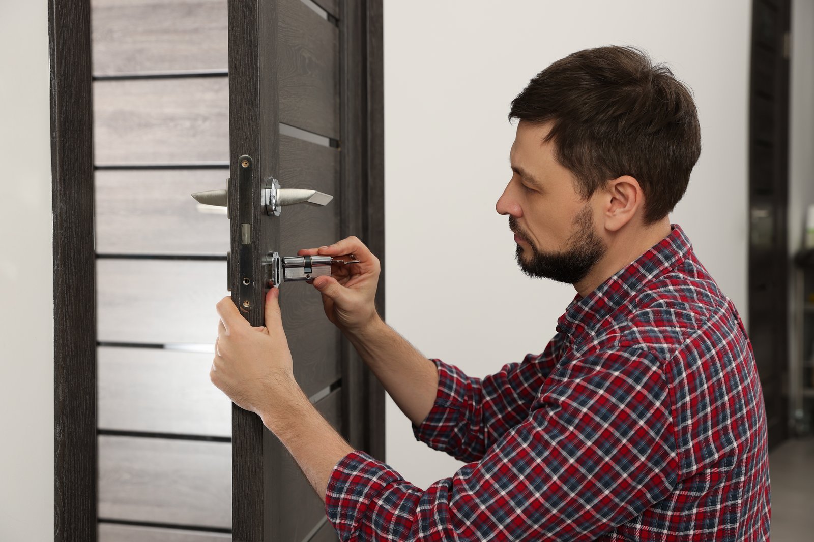 A locksmith replacing a euro cylinder lock