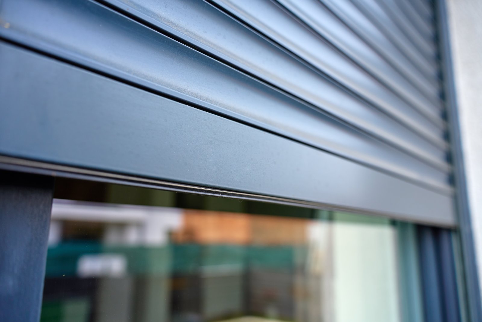 A close-up view of a commercial security roller shutter on a shop premises