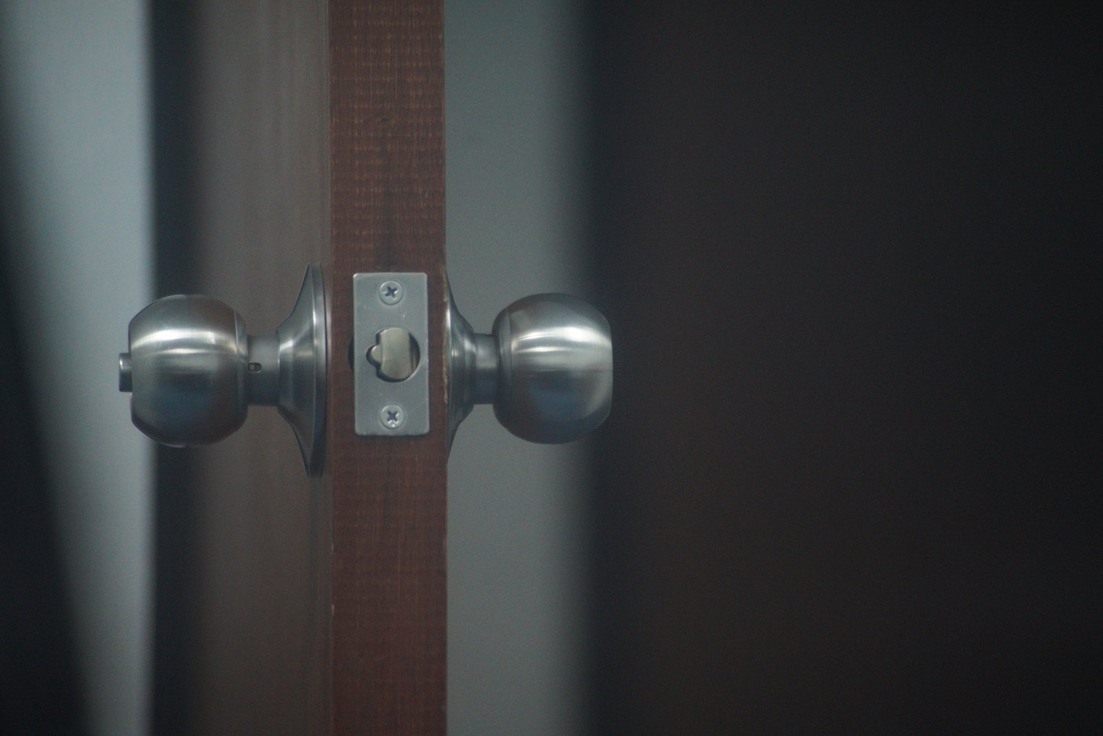 A close-up of matching door knobs and a latch mechanism fitted into a door edge