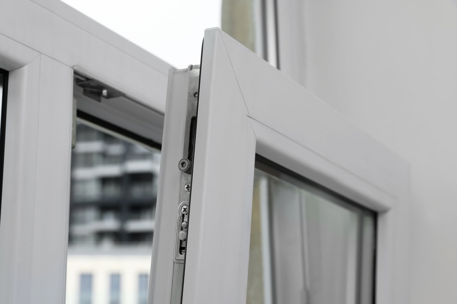 A close-up of a multipoint door lock mechanism fitted into a white door edge