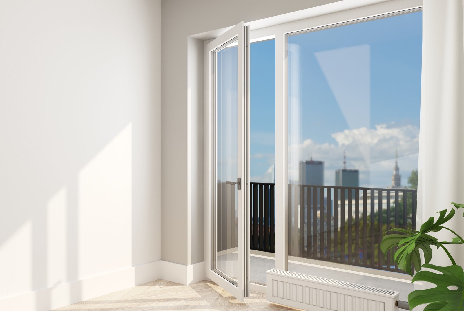 A part-open white uPVC balcony door with a city view beyond