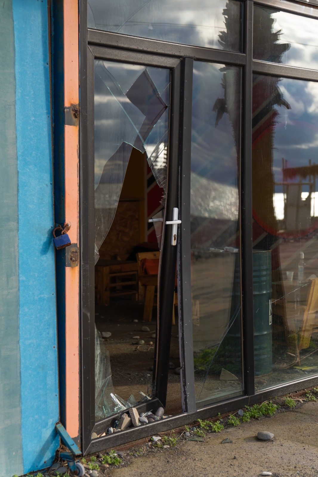A damaged commercial entrance requiring securing work