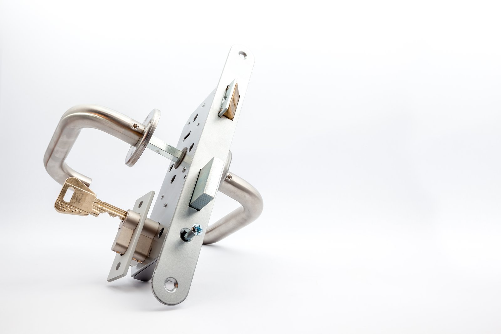 A euro cylinder lock and handle mechanism photographed on a plain background